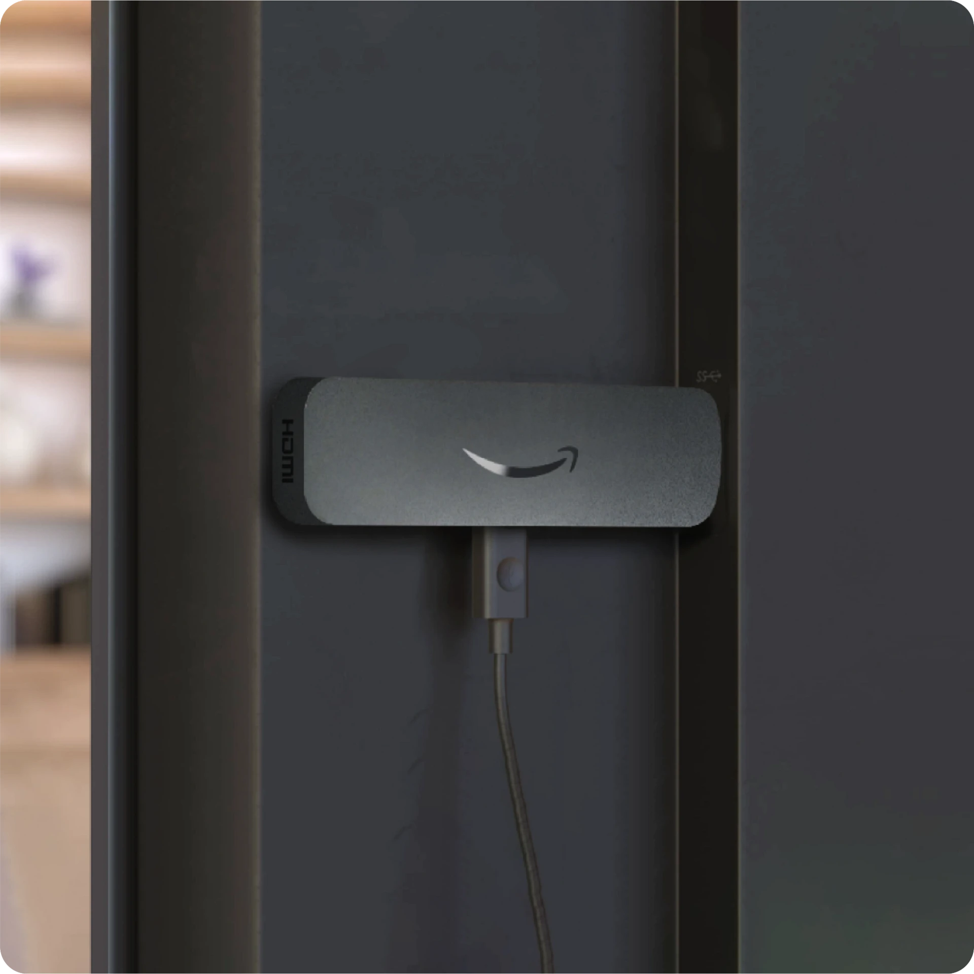 Amazon Signage Stick plugged into the HDMI port on the back of a TV