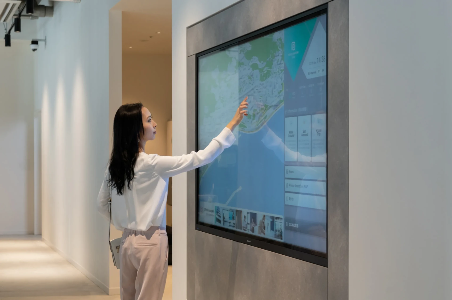 Campus entrance with a large digital directory showing a building map and department locations