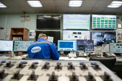 Engineering team monitoring system health and incidents on a wall display