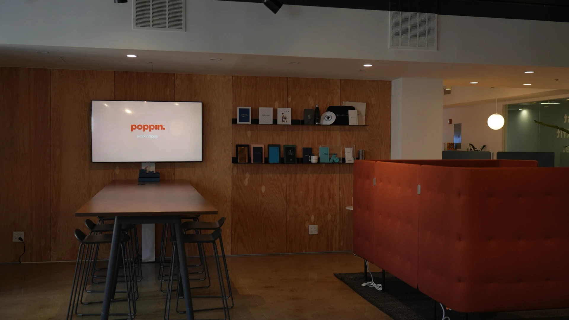 Large digital display screen mounted on a wall in a gallery-style exhibition space
