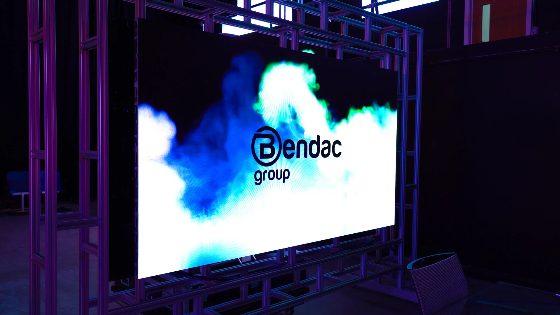 Large bright LED wall displaying vivid promotional content in a dark venue