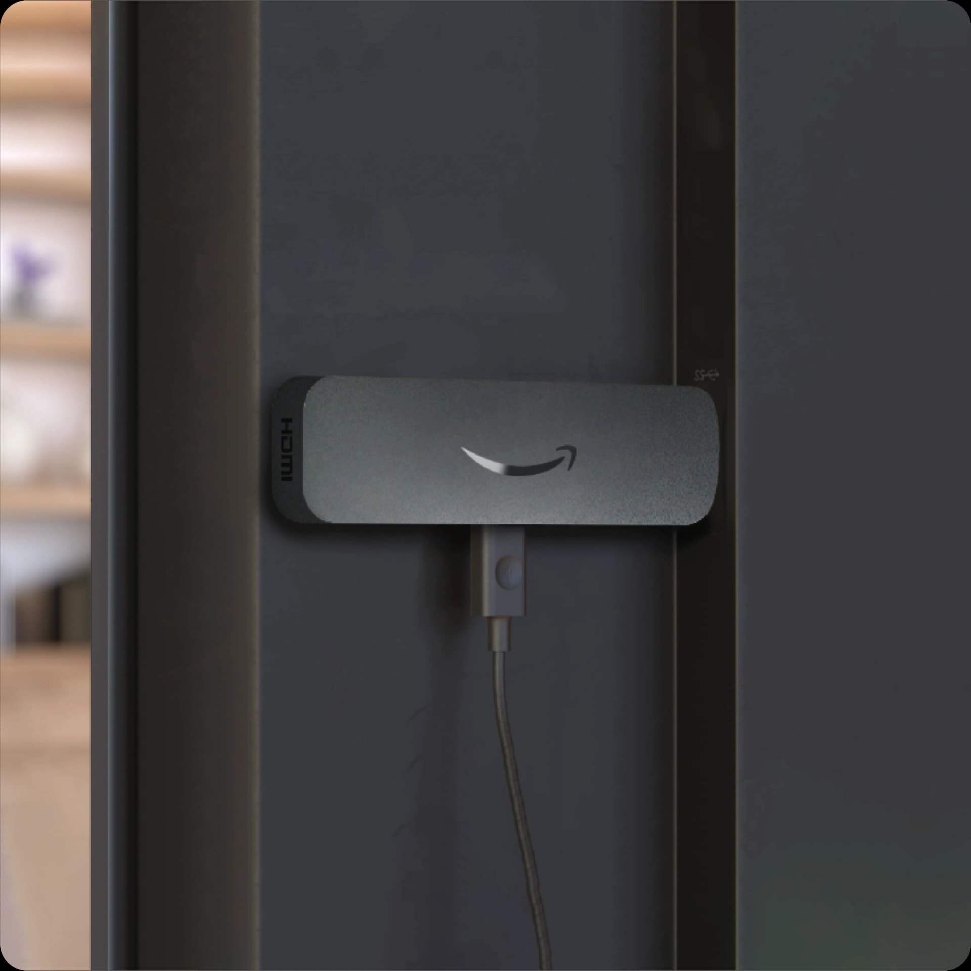 Amazon Signage Stick plugged into the HDMI port on the back of a TV