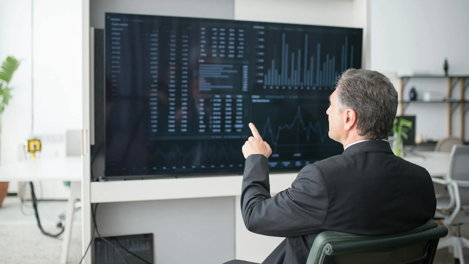 Sales dashboard displayed on a wall-mounted screen showing pipeline and quota data
