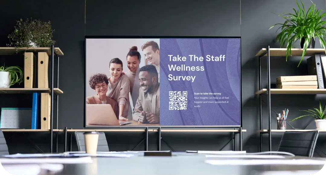 Marketing team office with large display showing campaign performance dashboards and analytics